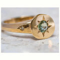 Golden oval ring with adjustable opening and a micro-inlaid star-shaped zircon stone on a zinc alloy band.