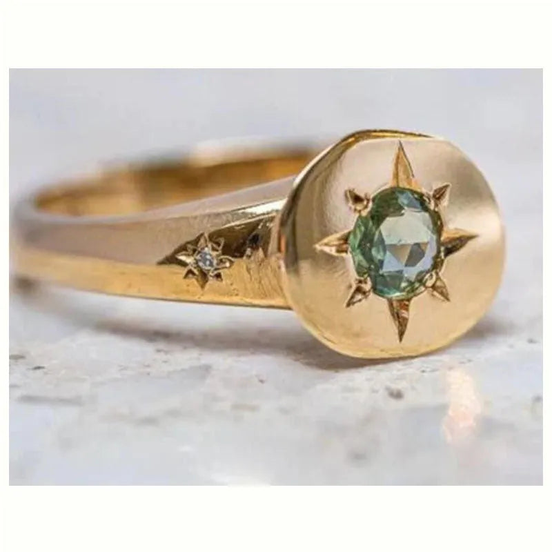 Golden oval ring with adjustable opening and a micro-inlaid star-shaped zircon stone on a zinc alloy band.