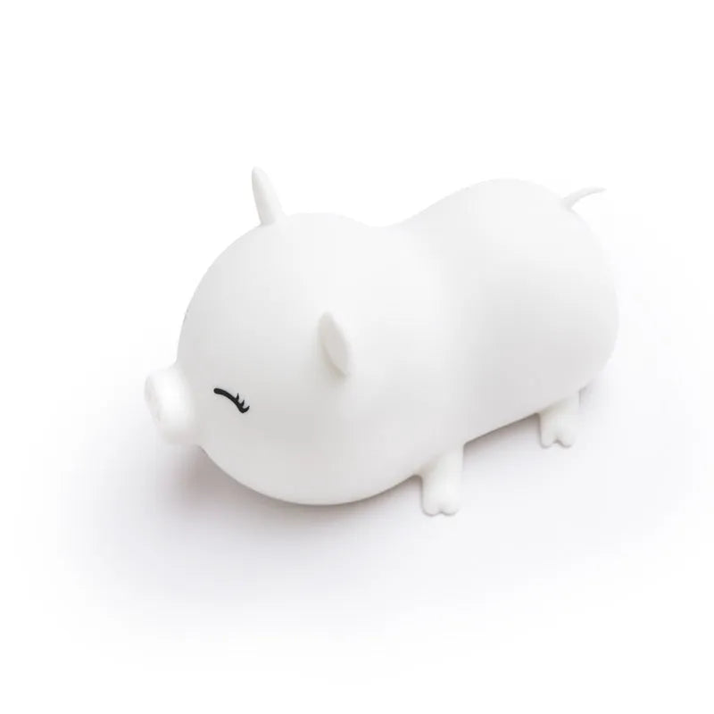 Dudu pig cartoon night light with silicone lampshade and warm yellow LED glow on a bedside table