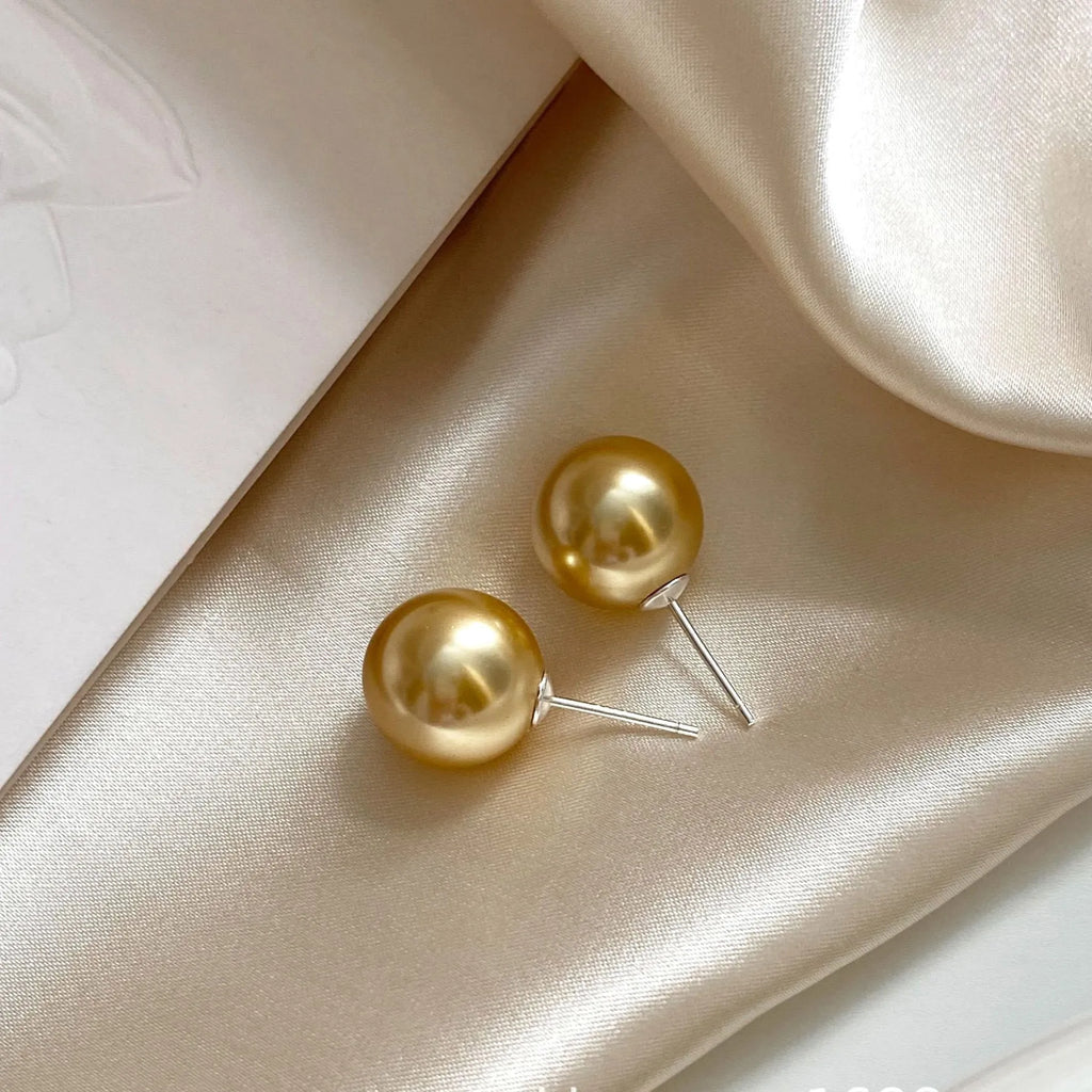 Retro geometric pearl stud earrings for women with an eight-point star design on silver setting.