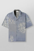 A man's loose-fitting, short-sleeve printed cardigan in a light colour for summer.
