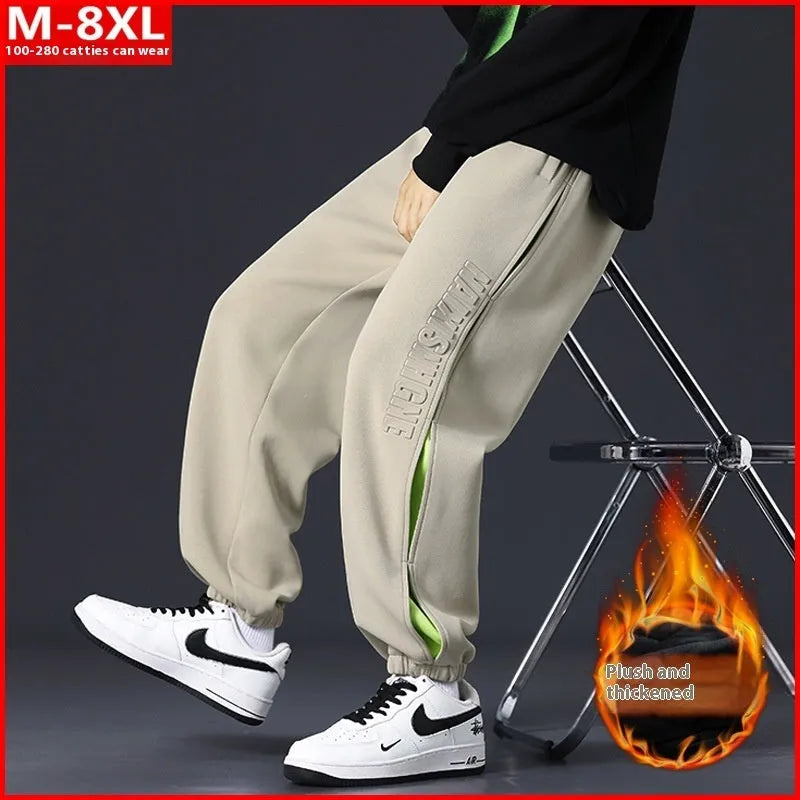 Men's loose fit cotton trousers with stitching detail and a banded ankle cuff.