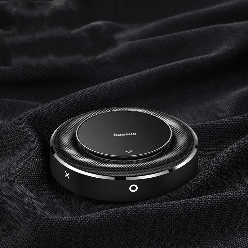 Black aluminium alloy round car perfume seat with aromatherapy tablets on a car seat.