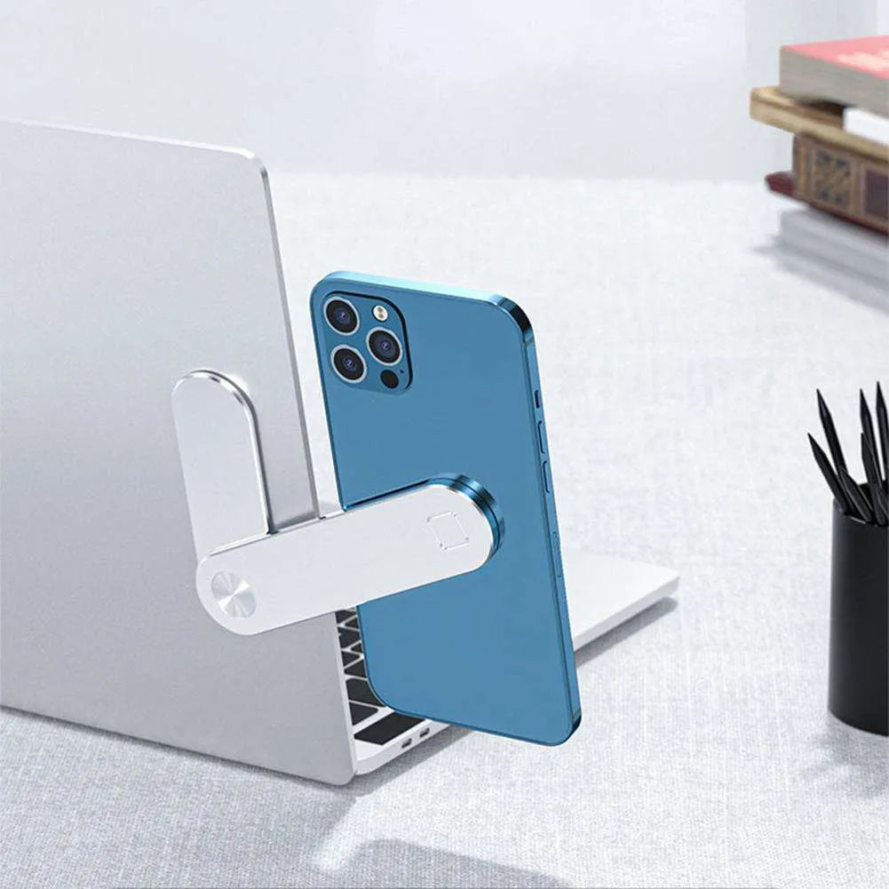Black aluminium magnetic phone holder clipped to side of a silver laptop.