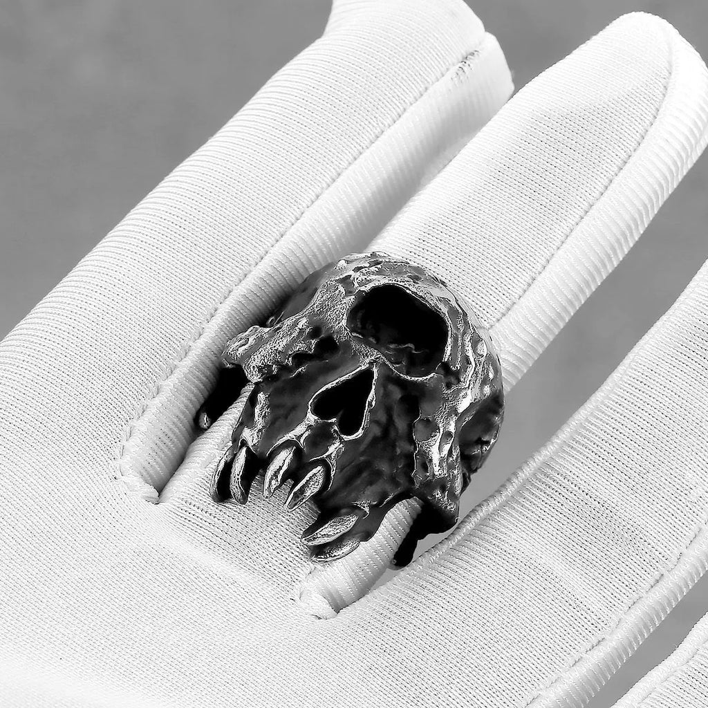 Alloy one-eyed skull ring in a retro electroplated finish, shown on a finger.