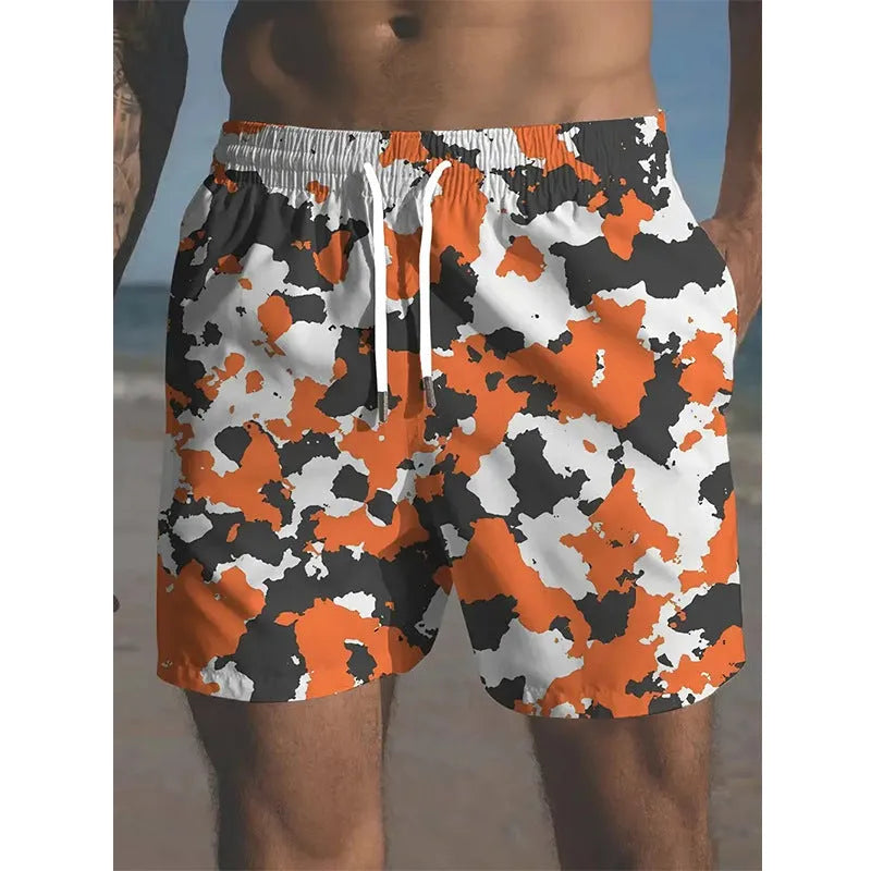 Colourful printed men's beach shorts with an elastic waistband on a neutral background.