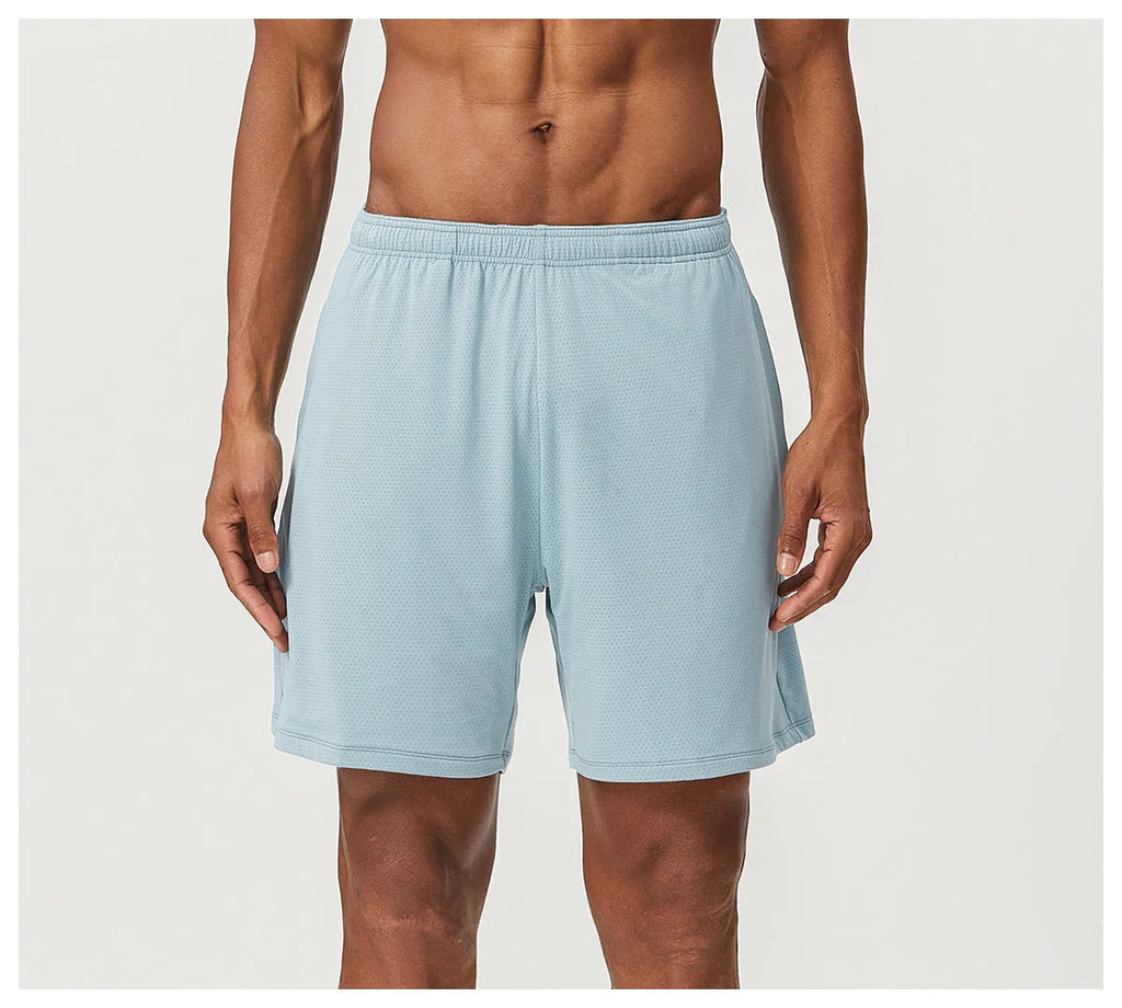 Man wearing khaki double-layer nylon running shorts during a workout.