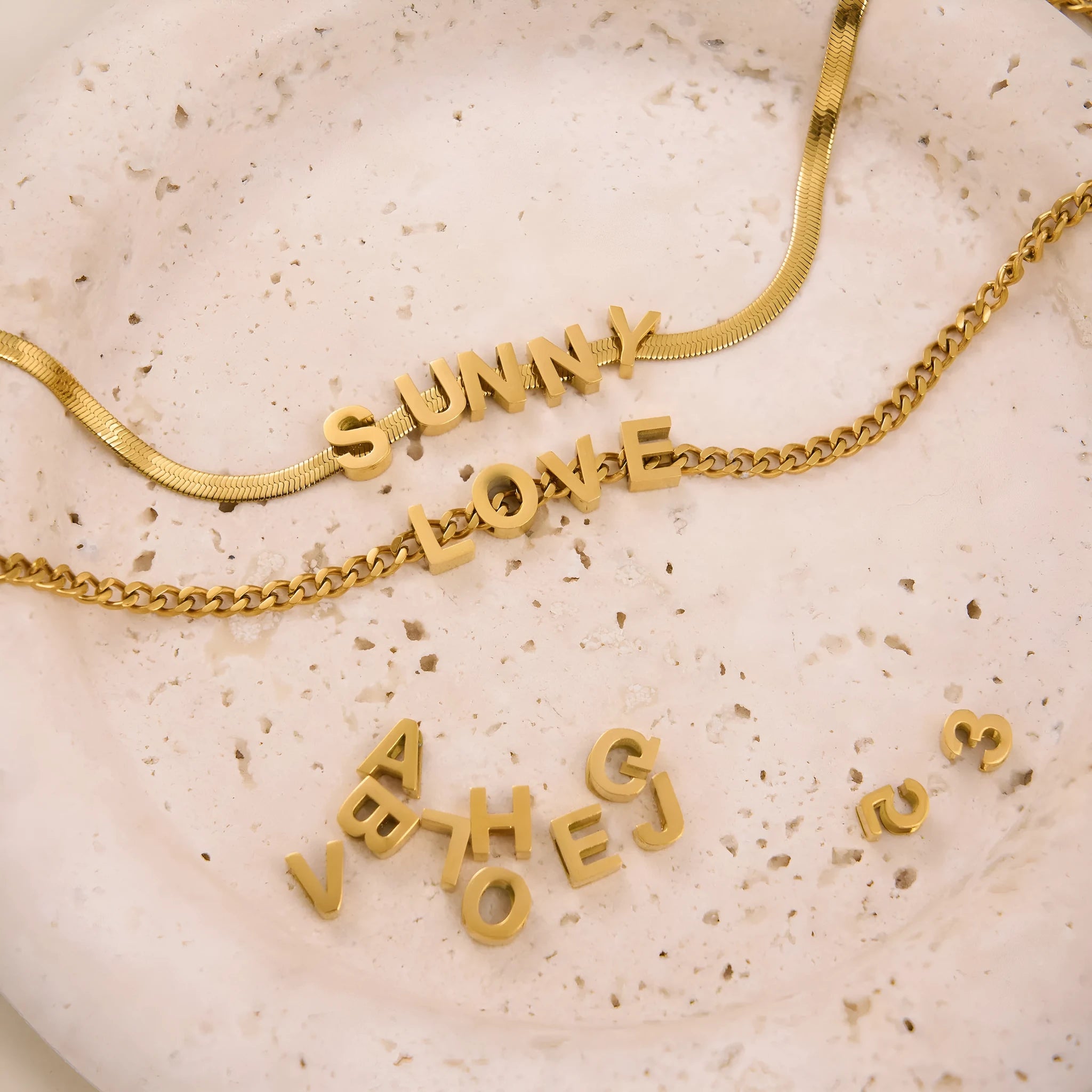 Gold electroplated titanium steel necklace with the letter 'A' pendant on a 40.5 cm chain.