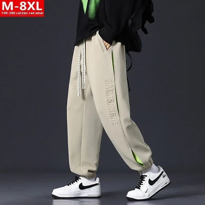 Men's loose fit cotton trousers with stitching detail and a banded ankle cuff.