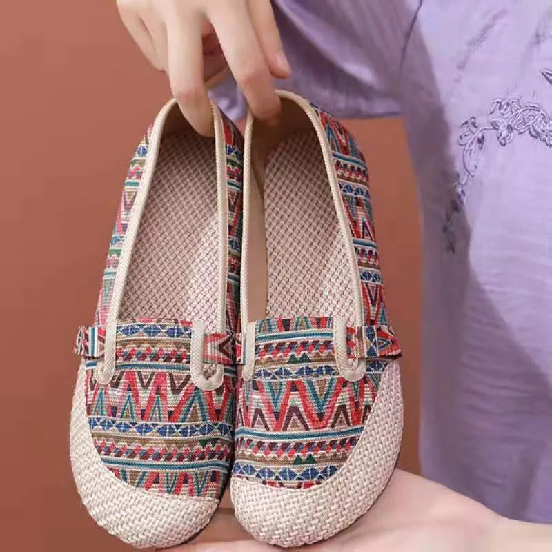 Women's ethnic style flat cloth shoes in red with colour stitching and a beef tendon sole.