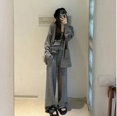 Women's light brown knit cardigan, vest, and loose trousers three-piece set laid flat.