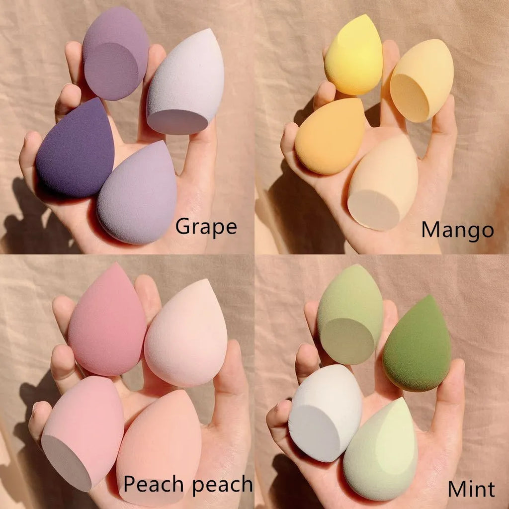 Four makeup egg beauty blenders in grape, mango, mint, and peach colours, each approximately 6cm in size