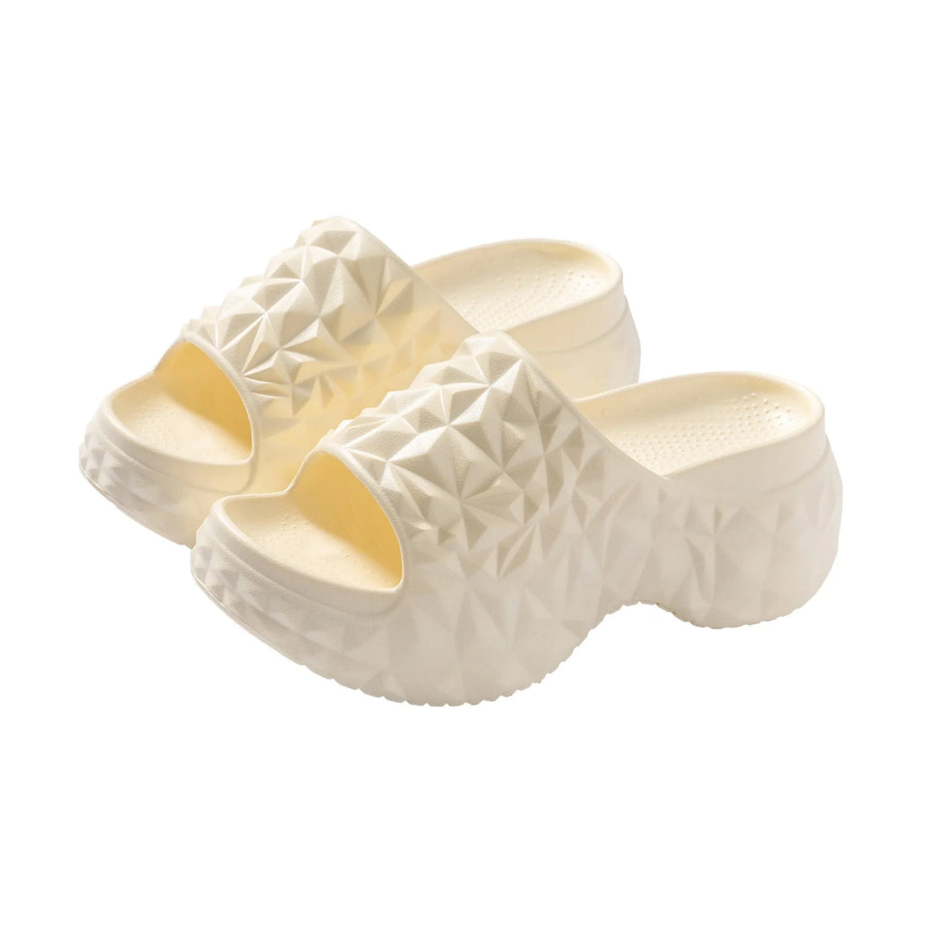 A pair of khaki high heel flip flop slippers made from injection moulded EVA with a thick sole.