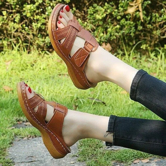 Women's red peep toe wedge sandals with a velcro strap closure on a fish mouth hollow wedge heel.