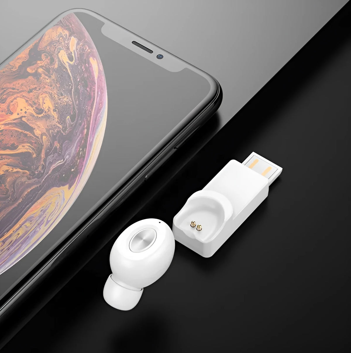 True wireless Bluetooth headset on magnetic car charging base, black colour, with silicone ear caps