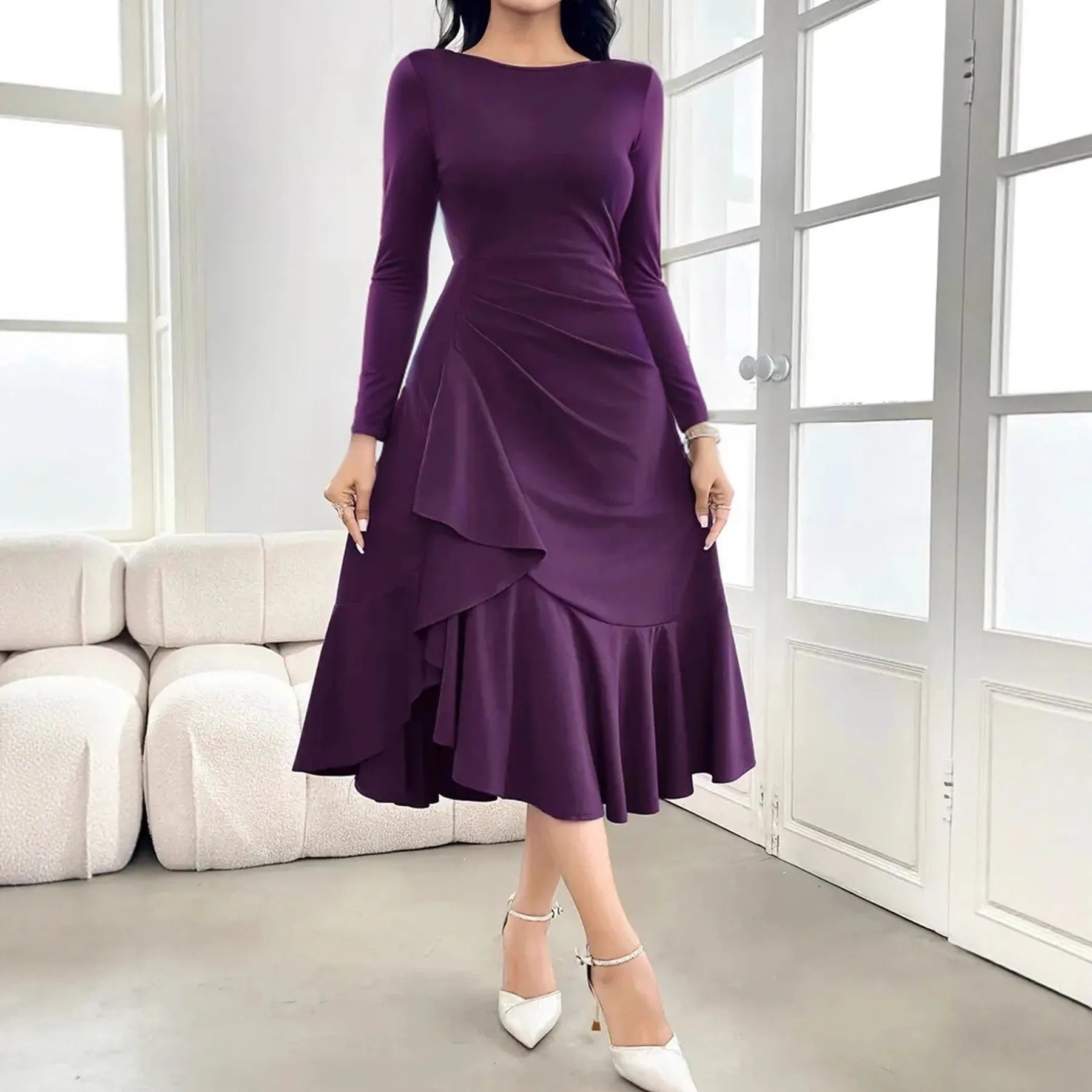 A purple women's long sleeve dress with ruffles and a round neck, shown on a hanger.