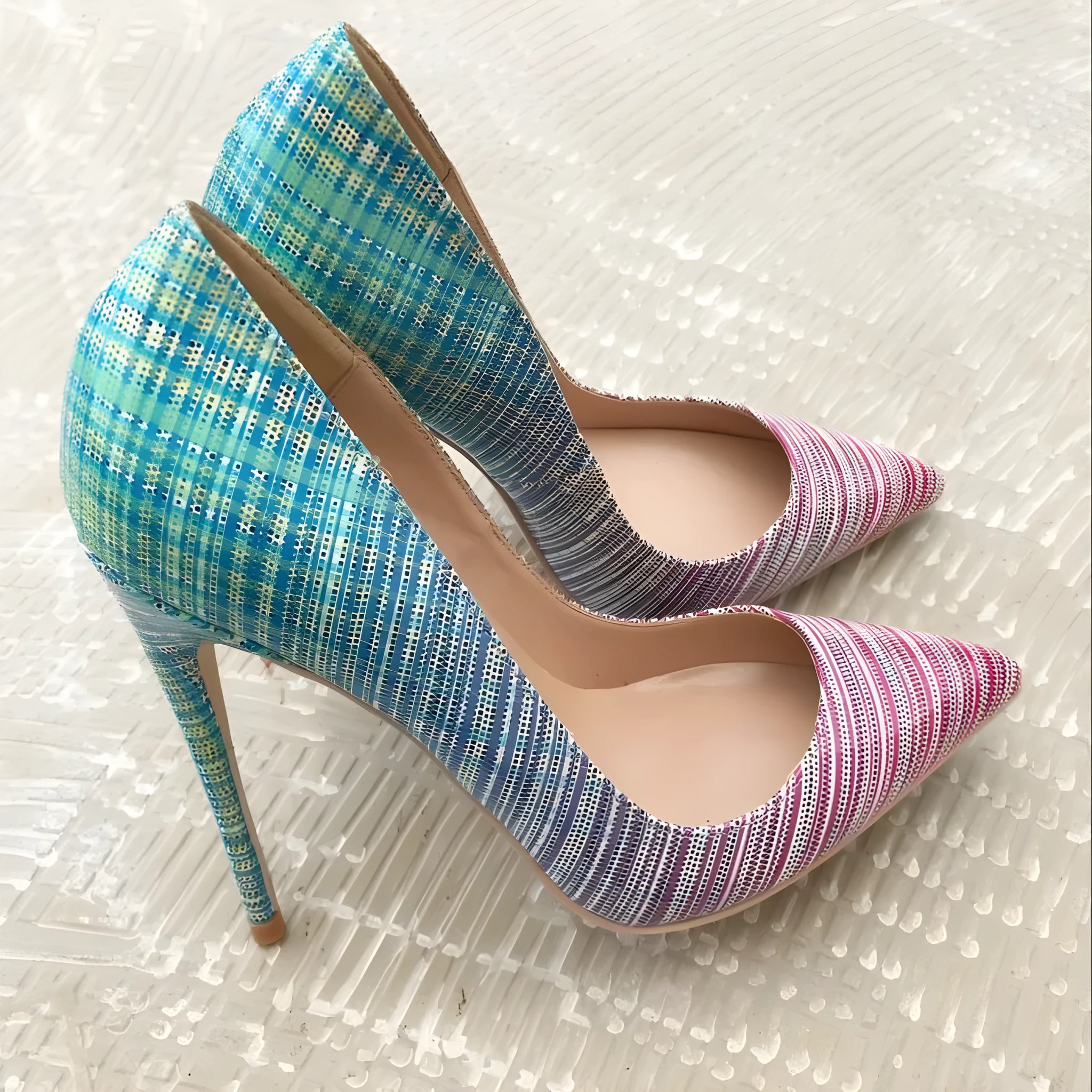 Pink to blue gradient patent leather ladies high heel shoe with pointed toe on a white background