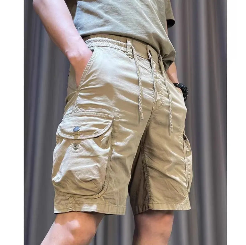 Korean-style loose straight overalls trousers in khaki with multiple pockets and a fifth-pants length above the ankle.