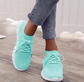 Beige ladies flying knit flat shoes with mesh upper, round toe, and low heel on a plain background