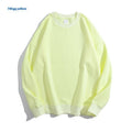 A woman's loose cotton off-shoulder sweater in a solid colour with long sleeves.
