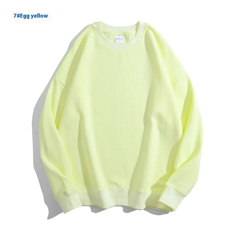 A woman's loose cotton off-shoulder sweater in a solid colour with long sleeves.