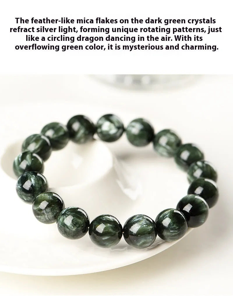 Close-up of a green dragon crystal bead bracelet with round geometry beads and a Ruyi charm.