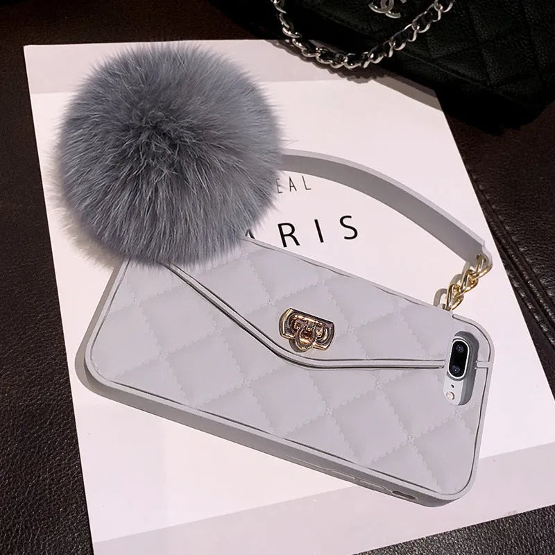 Soft plush hairball phone case with a grid pattern for iPhone, shown in dark green.