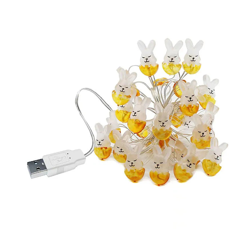 Easter carrot and rabbit shaped battery-operated LED decorative string lights on a dark background.