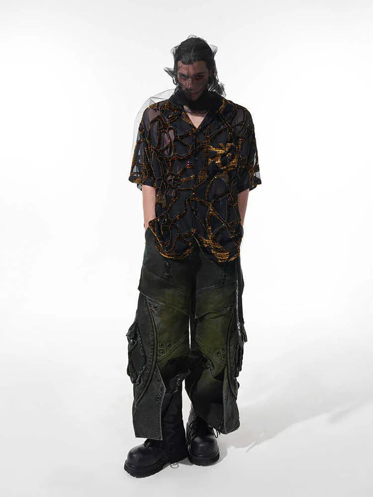 Man wearing a black and grey translucent snake pattern short-sleeved shirt with a lapel collar.