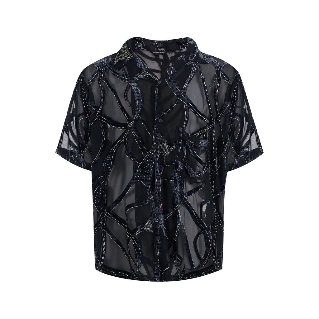 Man wearing a black and grey translucent snake pattern short-sleeved shirt with a lapel collar.