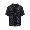 Man wearing a black and grey translucent snake pattern short-sleeved shirt with a lapel collar.