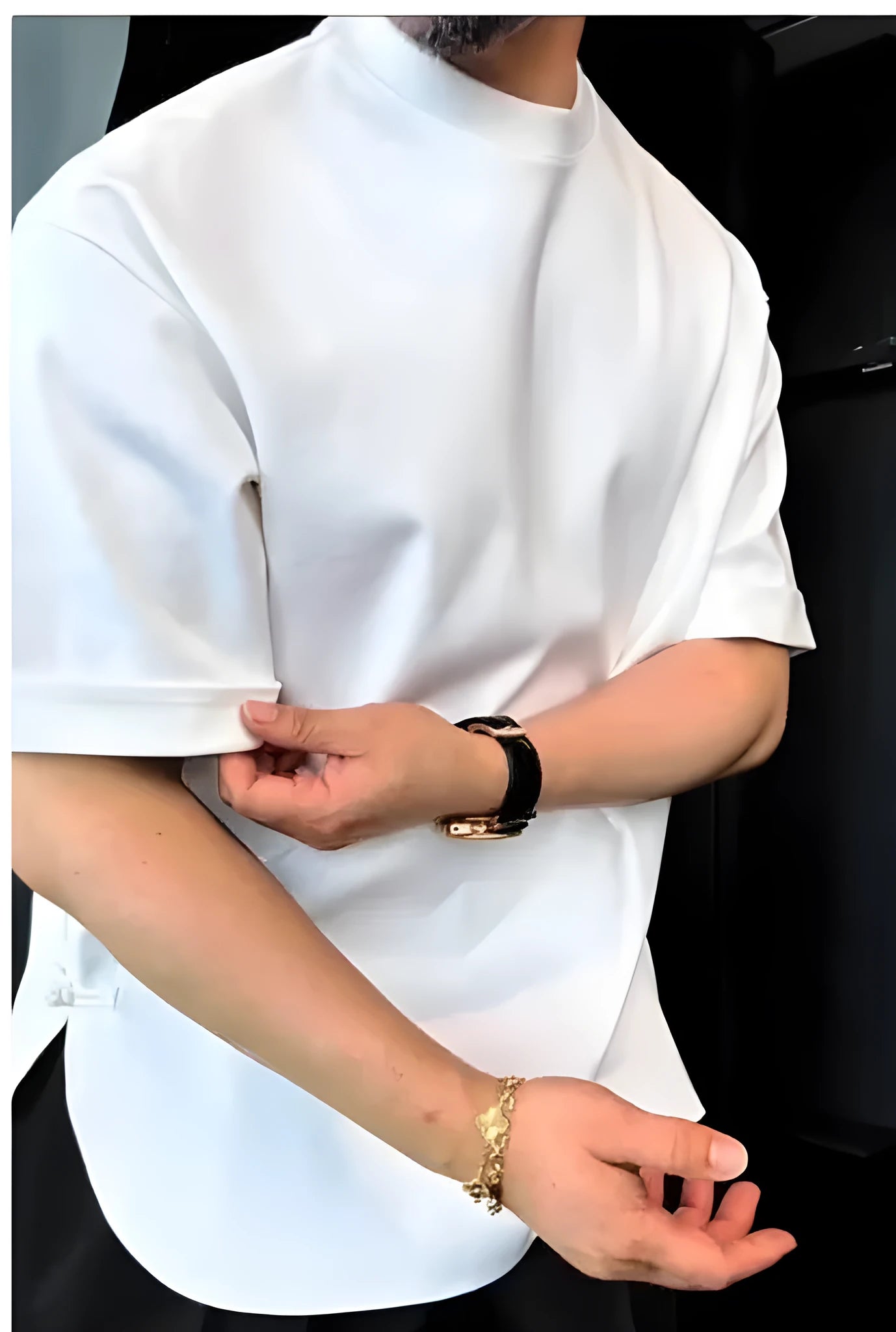Men's white buttoned round hem t-shirt laid flat, showing crew neck and distinctive button detail on the curved hem.