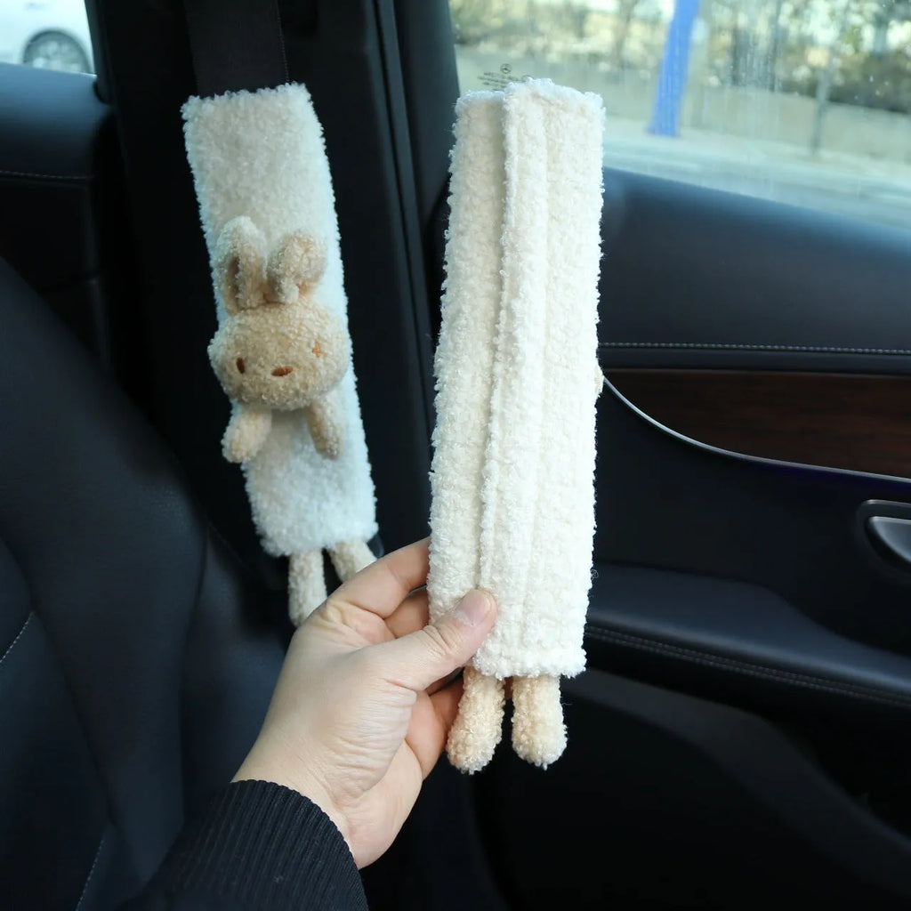 Cartoon plush lamb wool seat belt shoulder protector cover in Bear design on a car seat.