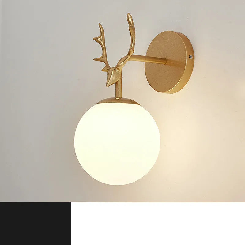 Minimalist round glass wall sconce with textured shade and black frame mounted on a white wall.