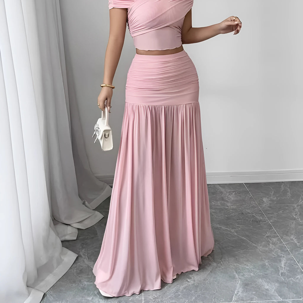 Women's pleated long skirt in polyester with irregular hem available in pink and beige sizes S to XXL
