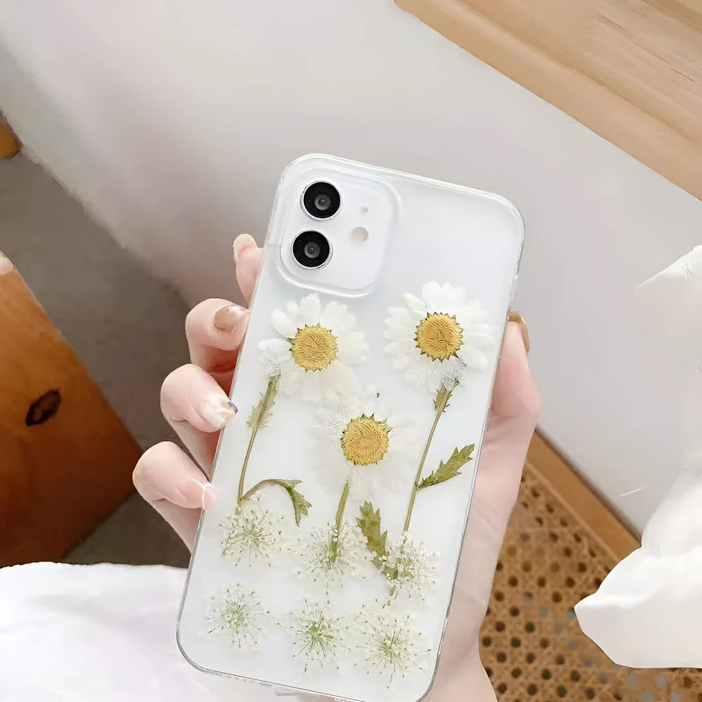 White TPU iPhone case with a raised epoxy daisy floral design on the back.