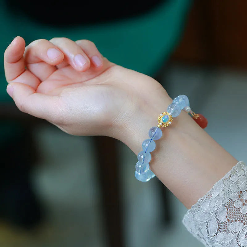 DIY adjustable aquamarine bead bracelet with pearl accents and a Chinese style fox Fengjiu charm.