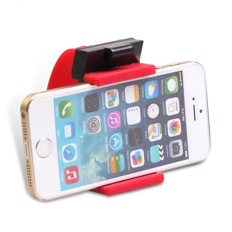 Black universal steering wheel phone clip holder with silicone pad mounted on a car steering wheel.