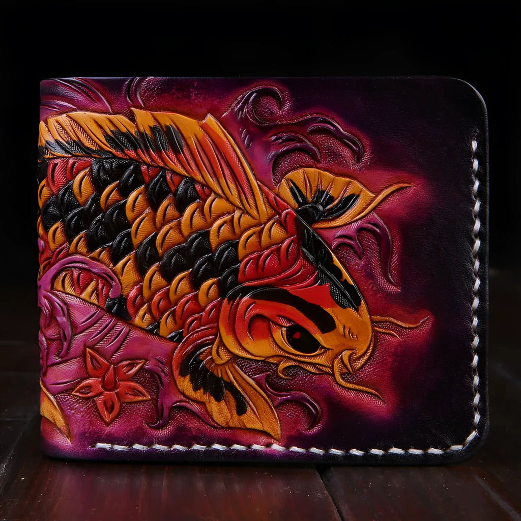 Men's hand-carved short leather wallet in blue, showing textured detail and compact size next to a card for scale.