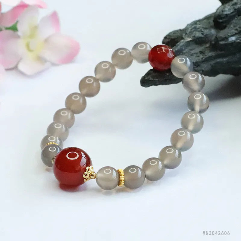Smoky purple and red agate bracelet with 8mm geometric beads on a white background.