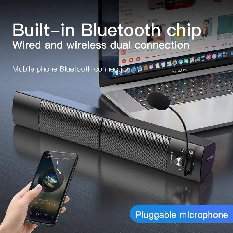 Small phantom black Bluetooth speaker subwoofer with dual speakers and microphone on a desk