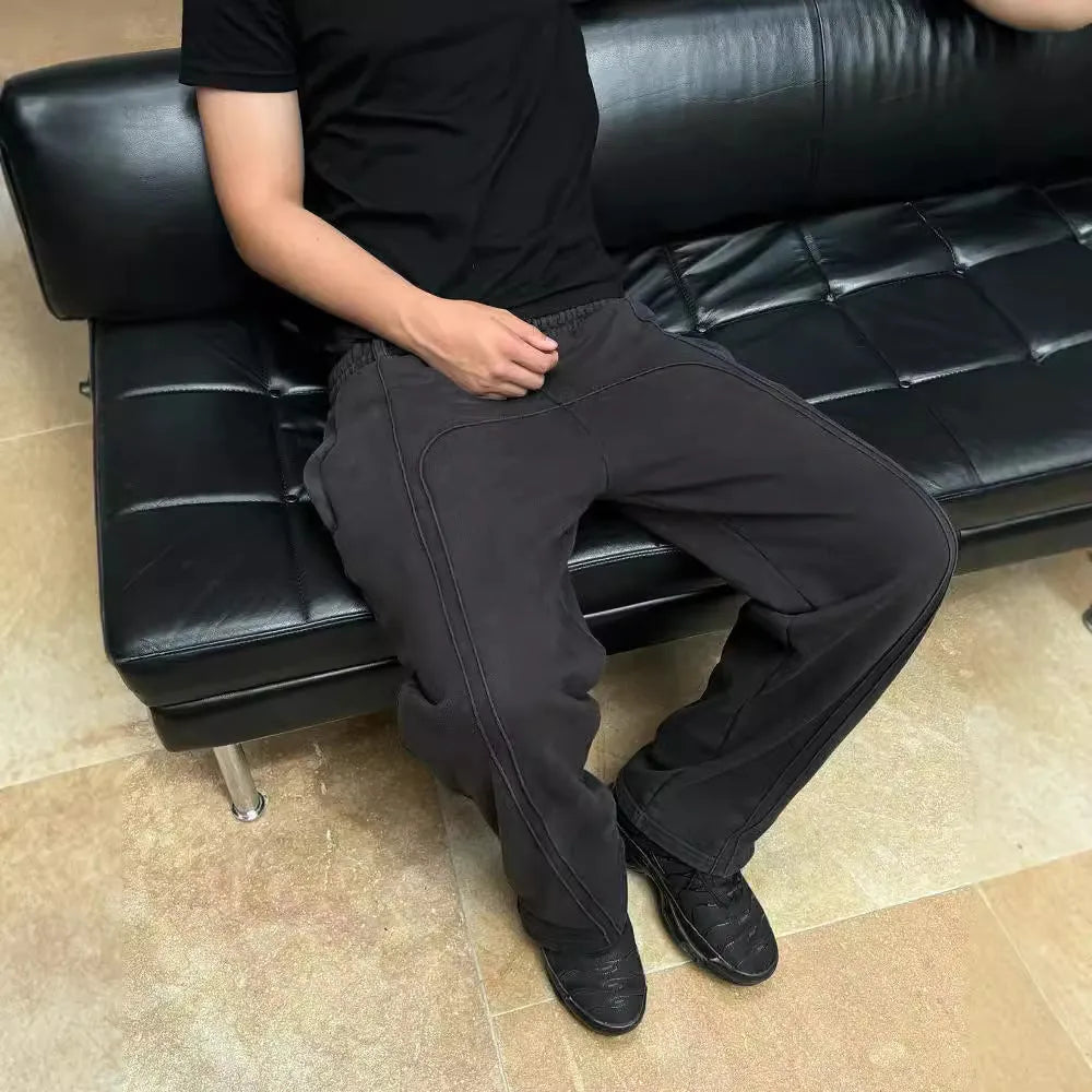 Men's loose cropped polyester sweatpants with quilted tooling style in black, grey, or green