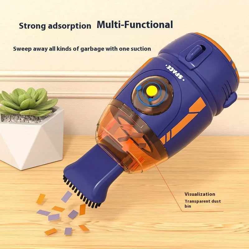 USB-powered handheld desktop vacuum cleaner in blue rocket design on a wooden desk next to a keyboard.