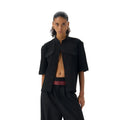 Handmade black loose fit half sleeve shirt with a shirt collar on a hanger.