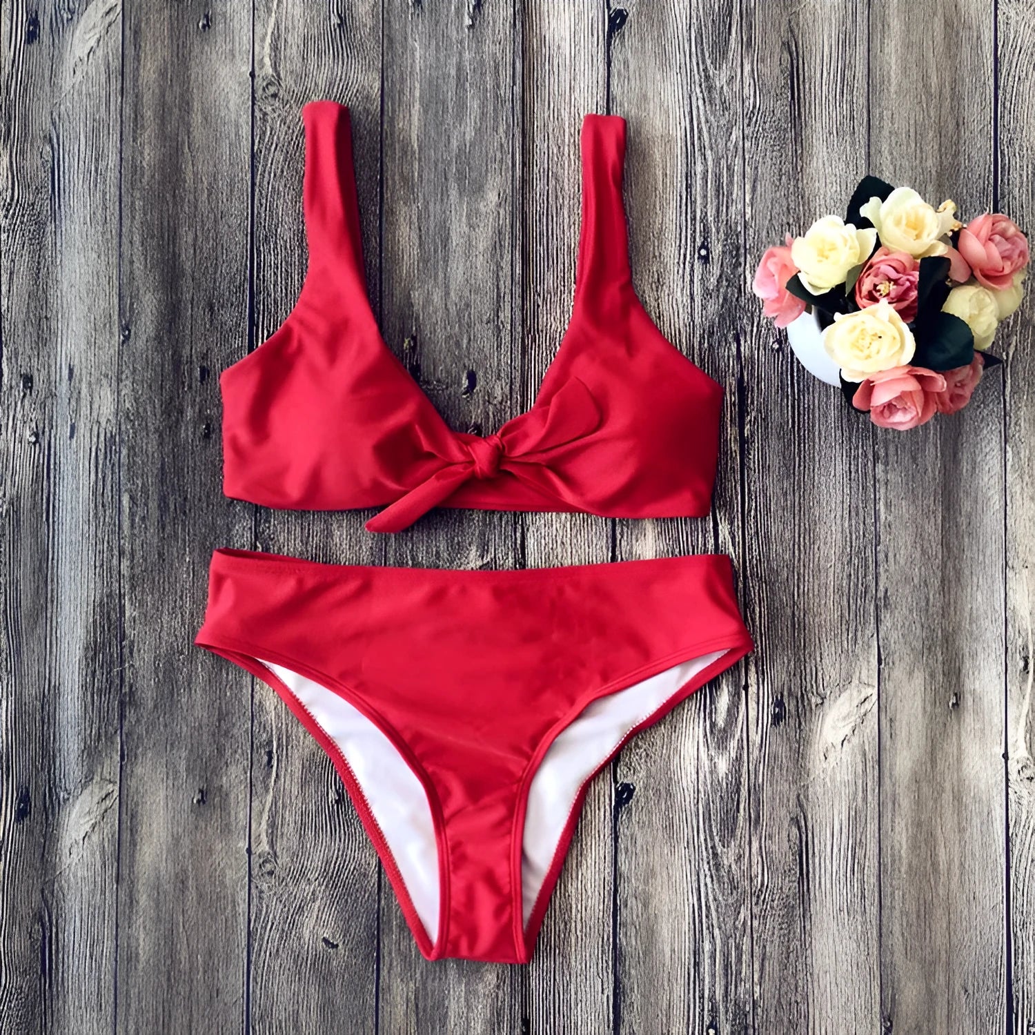 Women's solid colour bikini set in polyester with high-cut briefs, shown in wine red.