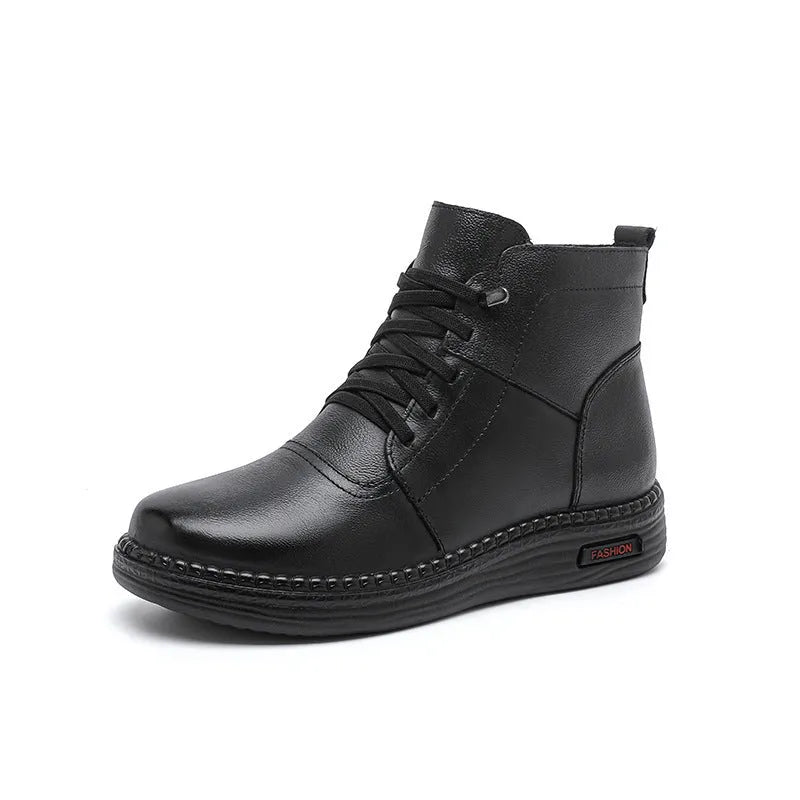 Pair of black cowhide ankle boots with side zipper, platform mid heel, and wool fleece lining visible at the top.