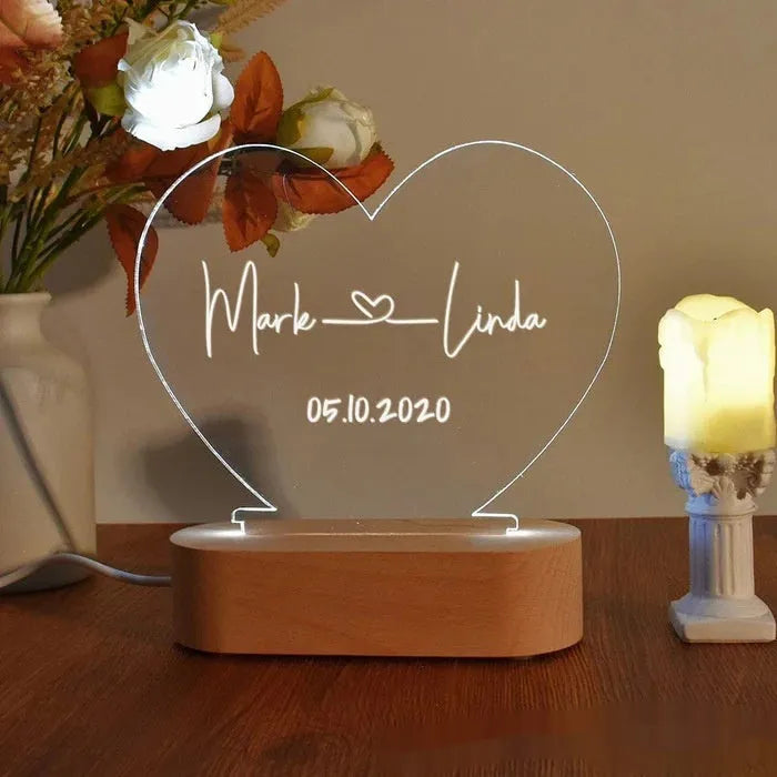 Custom transparent acrylic LED night light with personalised names and date engraving.