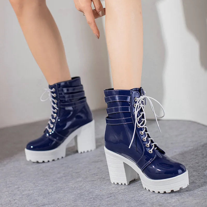 Women's black thick-heeled ankle boots with a lace-up front and waterproof platform on a rubber sole.