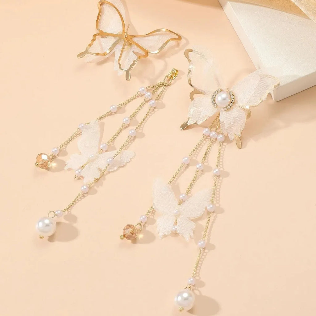 White butterfly-shaped earrings with lace detail, pearl tassels, and rhinestones on a copper alloy base.