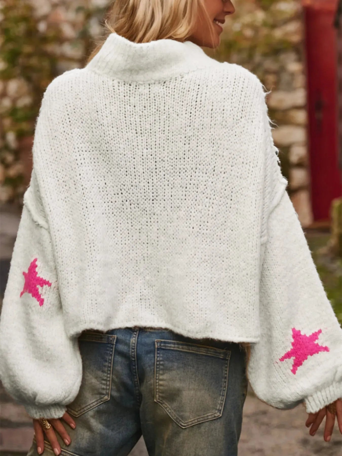 White women's loose turtleneck pullover with a thick imitation velvet texture and a five-pointed star pattern on the front.